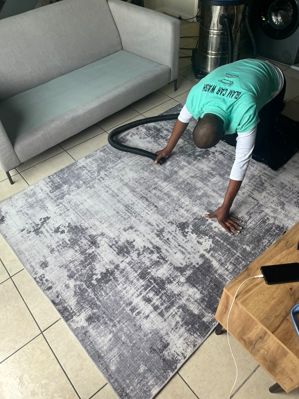 Glam Home Care technician deep-extracting a living room rug